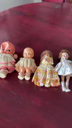 Four antique dolls.