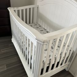 baby crib with mattress, rarely used because the baby always slept with his parents.