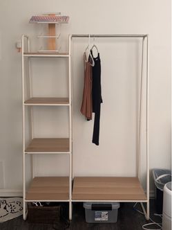 Clothing rack with wooden shelves and metal supports