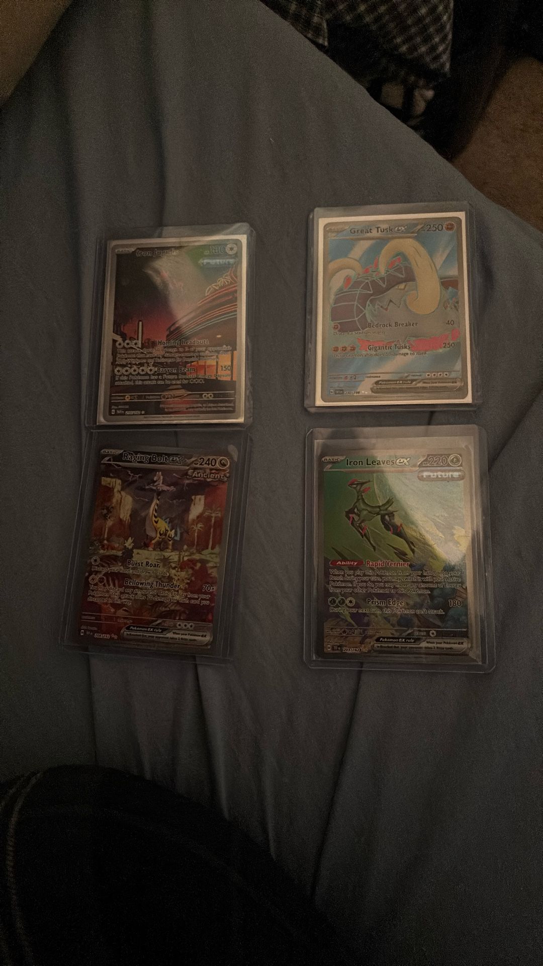 All 4 pokemon cards. Raging bolt SIR, Iron leaves SIR, a full art and a ir