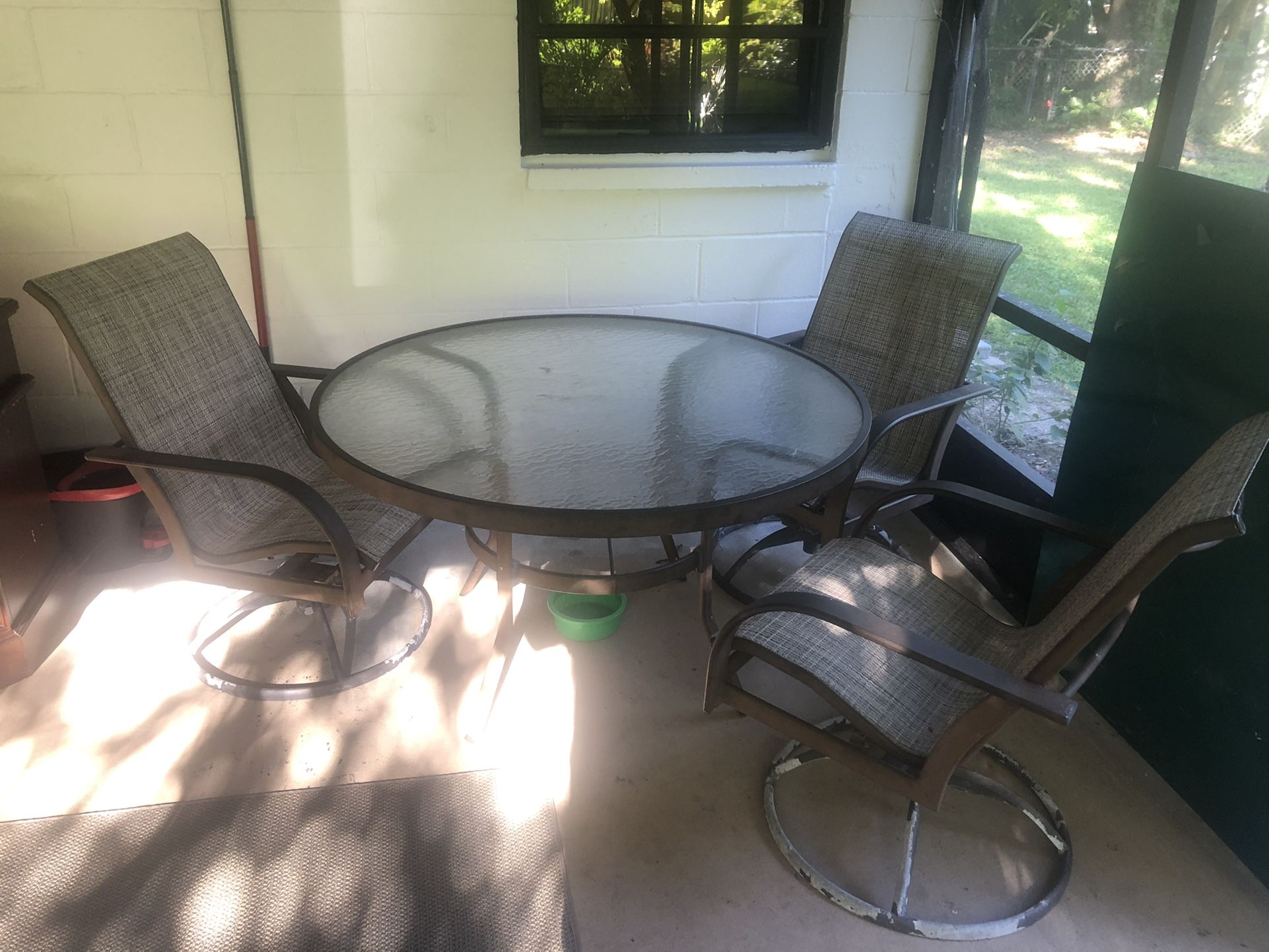 Patio table with three  swivel chairs. Previous buyer fell through. 