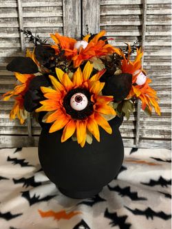 Black heavy vase / yellow orange sunflowers with eyeballs