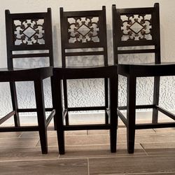 Three solid wood barstools
