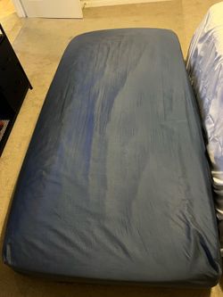 Twin XL bed with mattress topper and steel bed frame