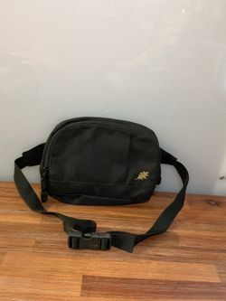 This black fanny pack from Logo Brands features an adjustable strap and a small embroidered gold logo.
