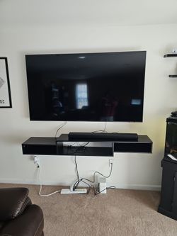 75' Samsung Flat Screen With Soundbar, Woofer, And Floating Shelf