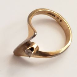 Stone set in a wave or abstract gold-plated band