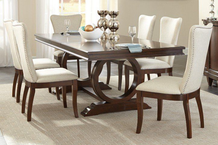 Traditional styling dining set features cherry finish & unique styling base
