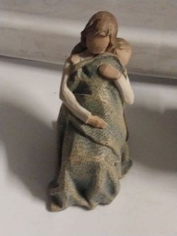 This is the "The Quilt" figurine from the Willow Tree collection by artist Susan Lordi.