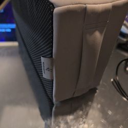 Based on its design and visual features, the item in the image is a memory foam cushion with a high-density support base and a breathable mesh exterio