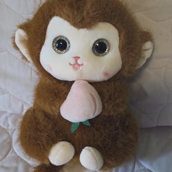 Kawaii Brown Monkey holding a peach