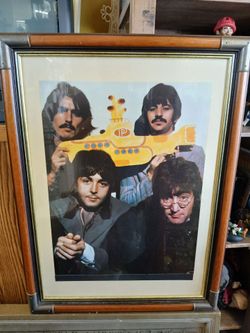 framed vintage poster features The Beatles