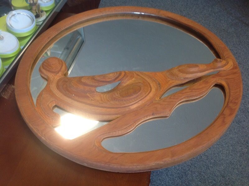 Antique mirror with a laying body on the middle