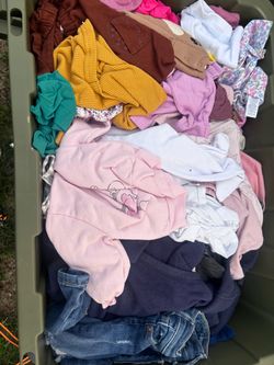 Box of baby girl and toddler boy clothes