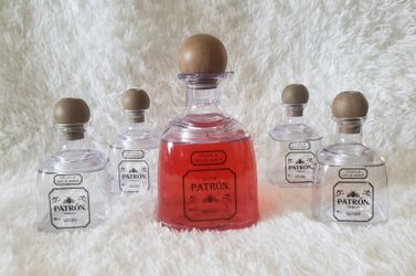 Patron shaped shaker cup and cup with straw.