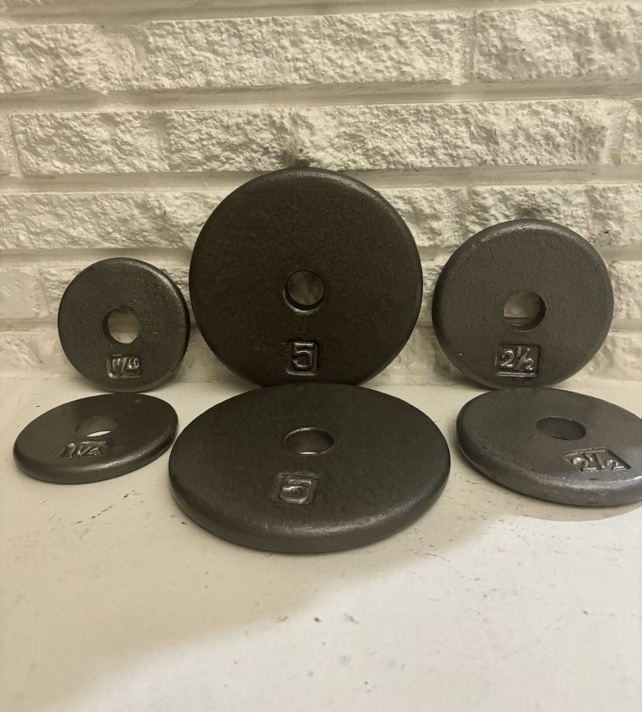 set of 6 cast iron weight plates for dumbbells 2 plates 5 lbs 2 plates 21/2 lbs 2 plates 11/4 los All 6 plates for $40