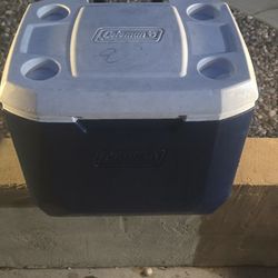 Large Coleman cooler in good working condition. Features heavy-duty wheels and pull handle for easy transport — great for tailgates, camping, road tri