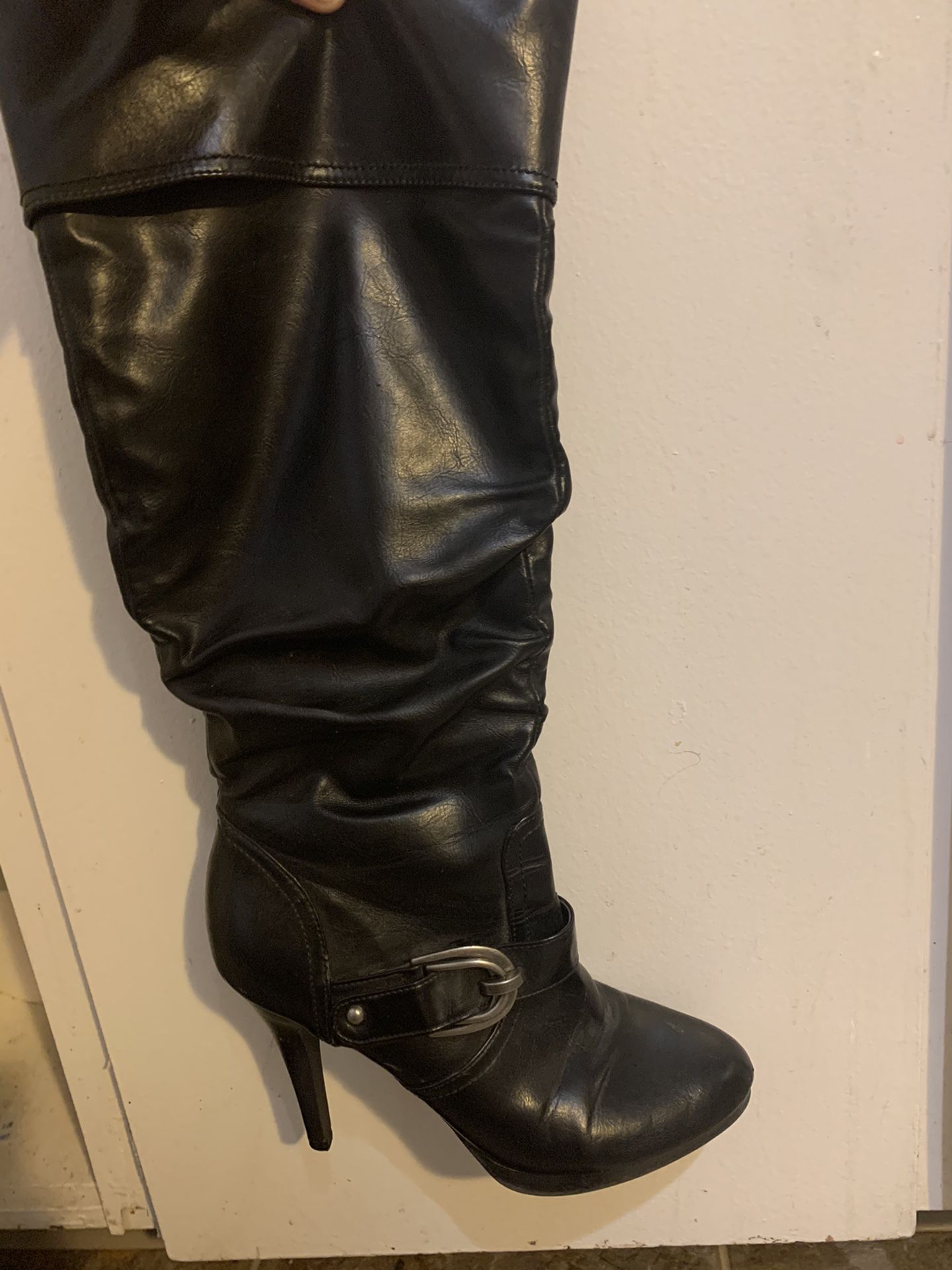 Tall black zip up boot heels.