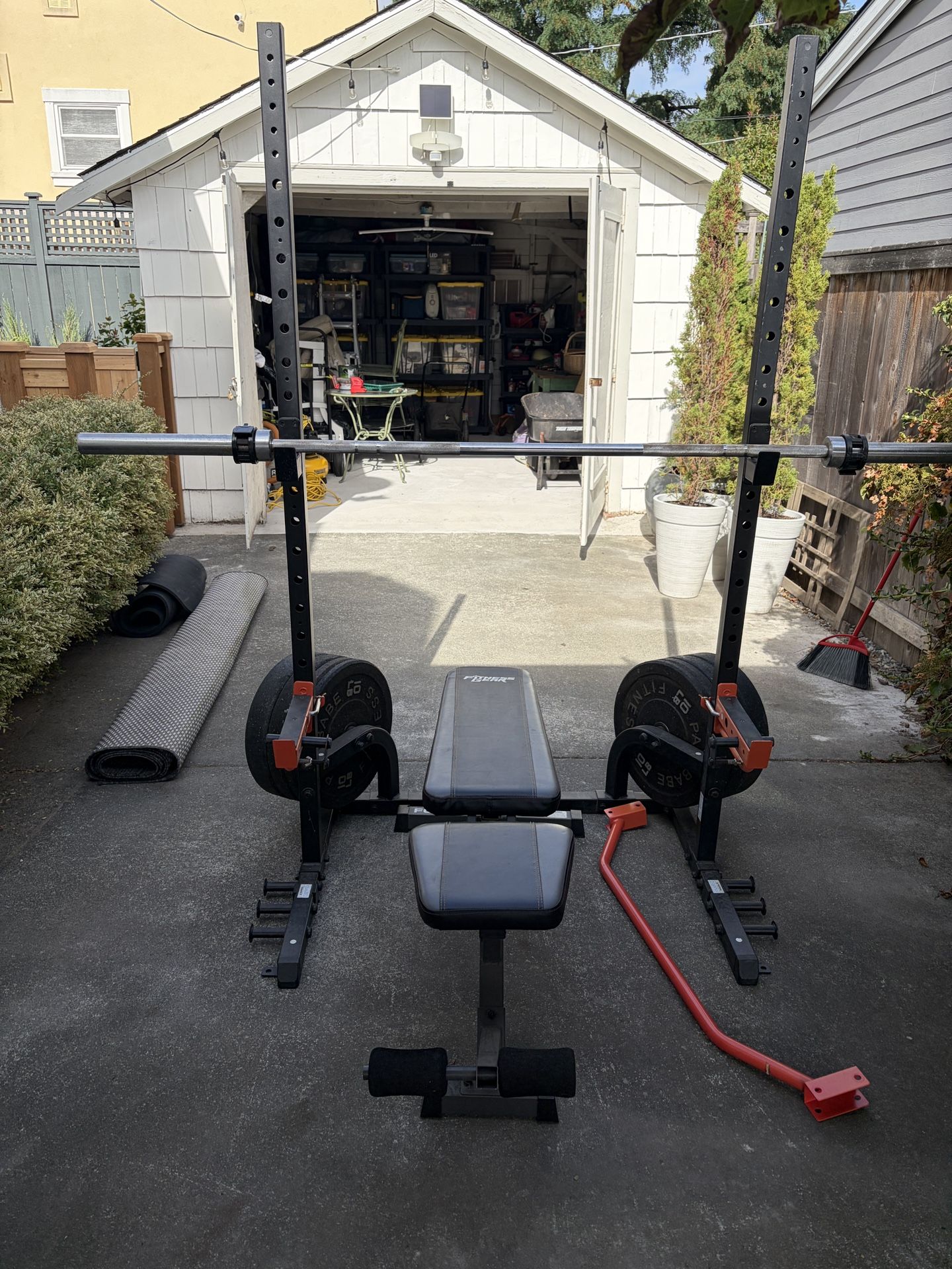Weight Rack with 180 Lbs Of Plates, Bench, Barbell, and Clamps