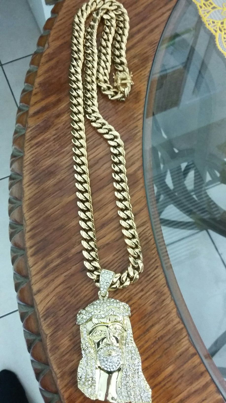 Very nice 14kt gold over stainless steel 12mm by 3oinch long Miami Cuban link Chain with nice jesus charm for sale !!