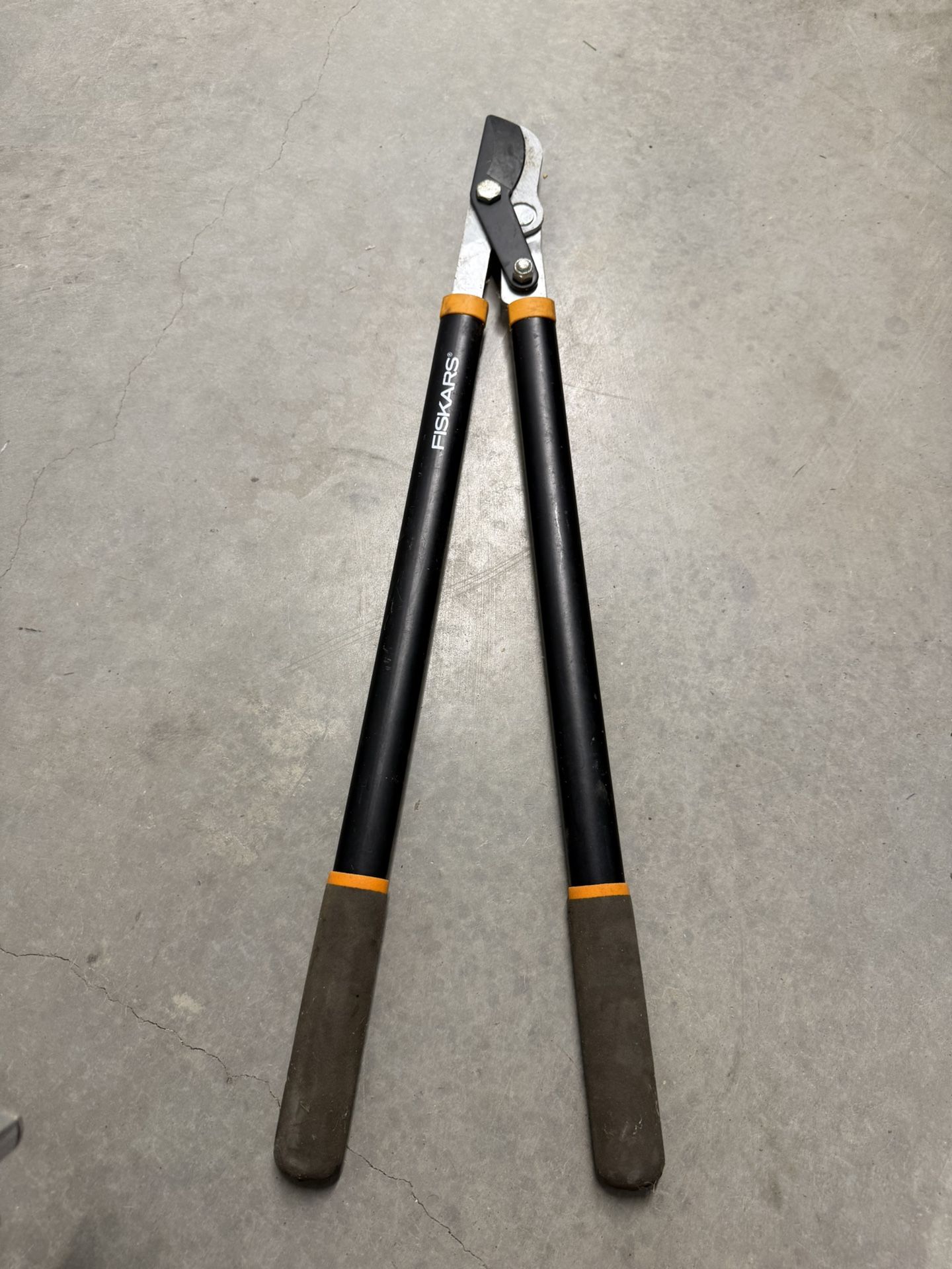 Fiskars Power-Lever Bypass Lopper, a type of gardening tool used for trimming branches.