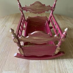Vintage delicate doll cradle hand painted in fuscia pink and gold. Showcase your favorite doll. 