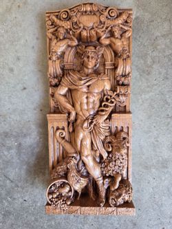 Hand carved image of Greek God