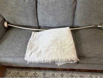 Curved shower rod with shower curtain and liner.