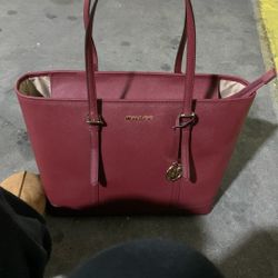 Michael Kors Jet Set Travel Large Saffiano Leather Tote Bag in a red or crimson color.