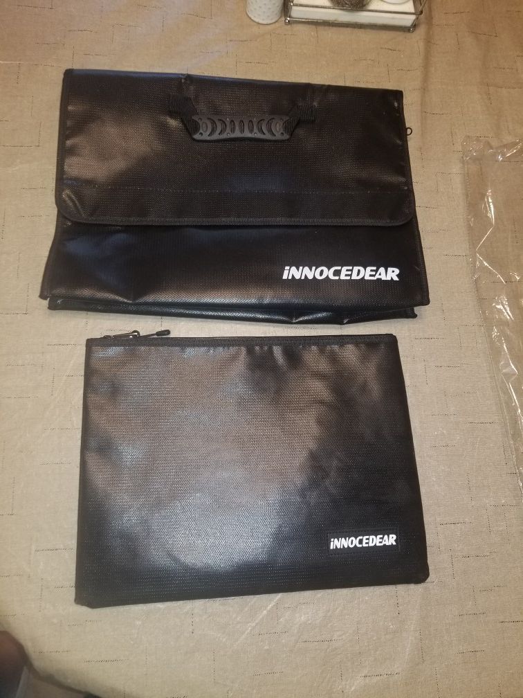 2 large fireproof safe bags, good for home or mobile transport of important documents, files, or cash. Also comes with lock for larger bag.