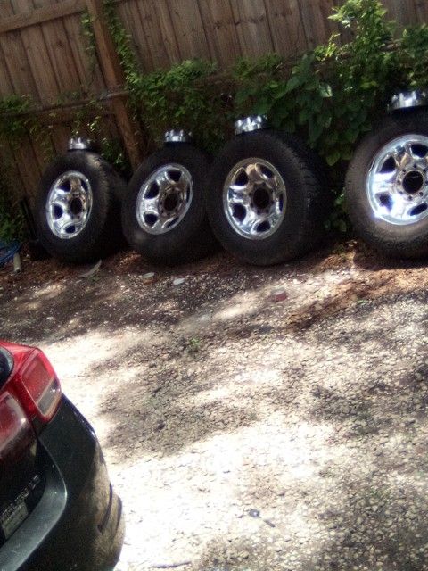 Four Rims On Tires With Caps