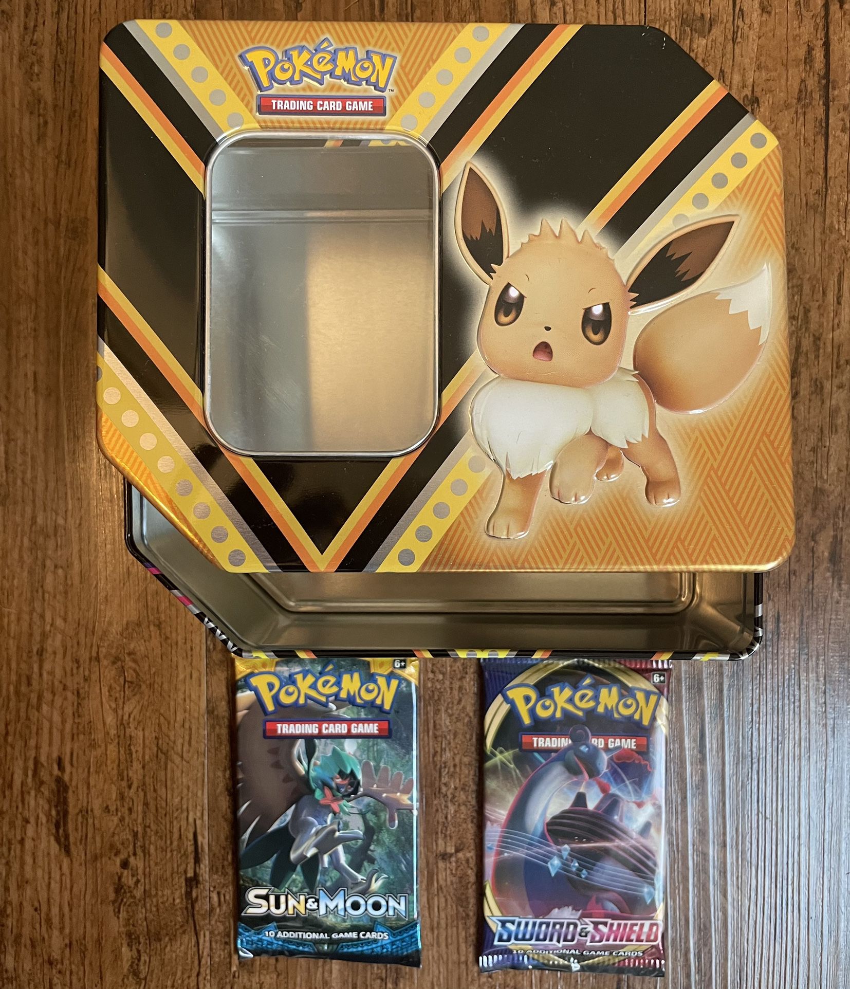 Lot Tin And two sealed Pokémon TCG packs - one eavh of Sword and Shield & Sun and Moon base set Booster Packs. Sun and Moon base set Booster Packs
