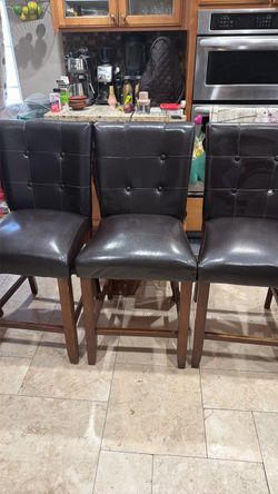 8 counter high chairs brown fox leather material  Some has button missing one chair has broken back piece as seen in last picture and little ripped on