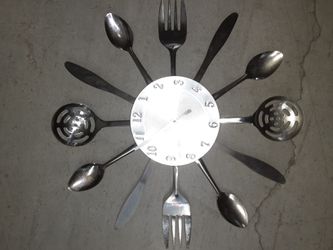 A household clock made out of silver kitchen utensils