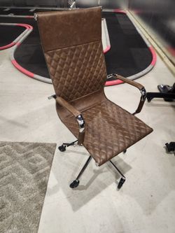 Office desk chair leather or leather ish  I'm not sure.  New