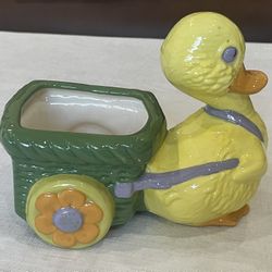 Vintage ceramic duckling planter pulling a basket. 