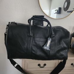 Black Steven Madden travel carry-on bag.