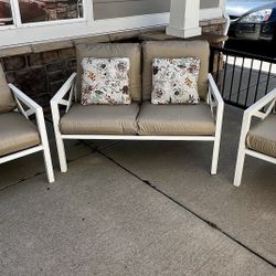 Pretty little three piece outdoor patio set in great condition with new cushion covers. Includes a loveseat and two armchairs, which all have plush de
