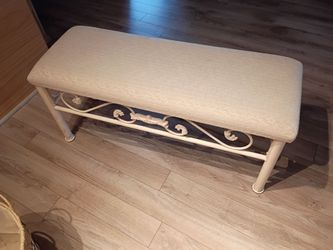 Cream colored metal bench