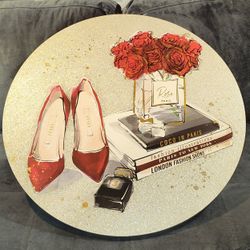 25"  ROUND GLITTERY CANVAS FASHION & DESIGN PAINTING / WALL SIGN WITH  RED HIGH HEELS, VASE OF ROSES, FASHION BOOKS & PERFUME BOTTLE.