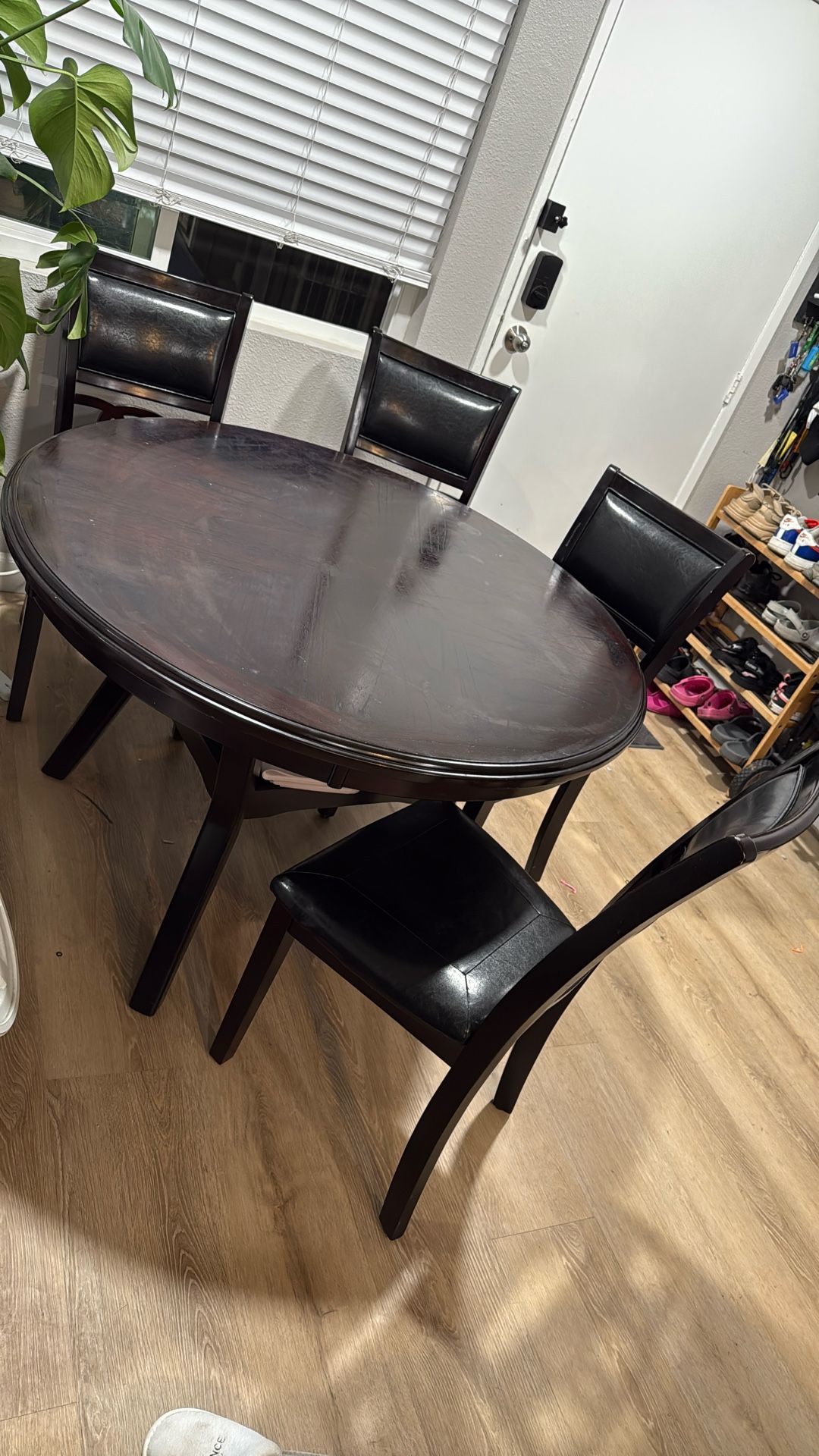 Dark Brown Circle Dining table And Cushioned chairs