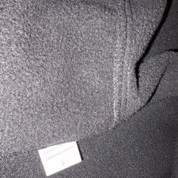 Camouflage pattern jacket with multiple pockets and a hood.