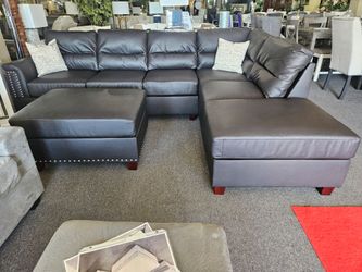 Brand new 112" x 85" reversible binded leather sectional + ottoman