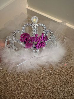 Sparkly silver tiara has pink glitter 'Bride to Be' text. Tiara has white feathers and attached white veil. For local pick up only please. I live in B