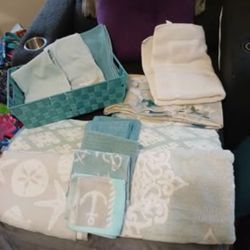 Four thick And Thirsty Luxurious towels, 6 washcloths, three hand towels, a bath mat, a shower curtain, and a bin
