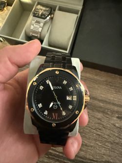 Bulova black and gold watch