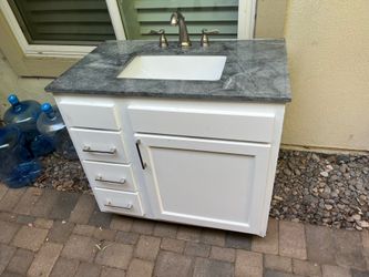 Vanity with stone top and fixtures 36”L x 36”H x 21”D