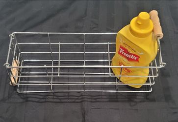 rectangular chrome wire condiment caddy with natural wood handles.