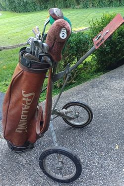 Set Of Golf Clubs With Rolling Spaulding Bag.