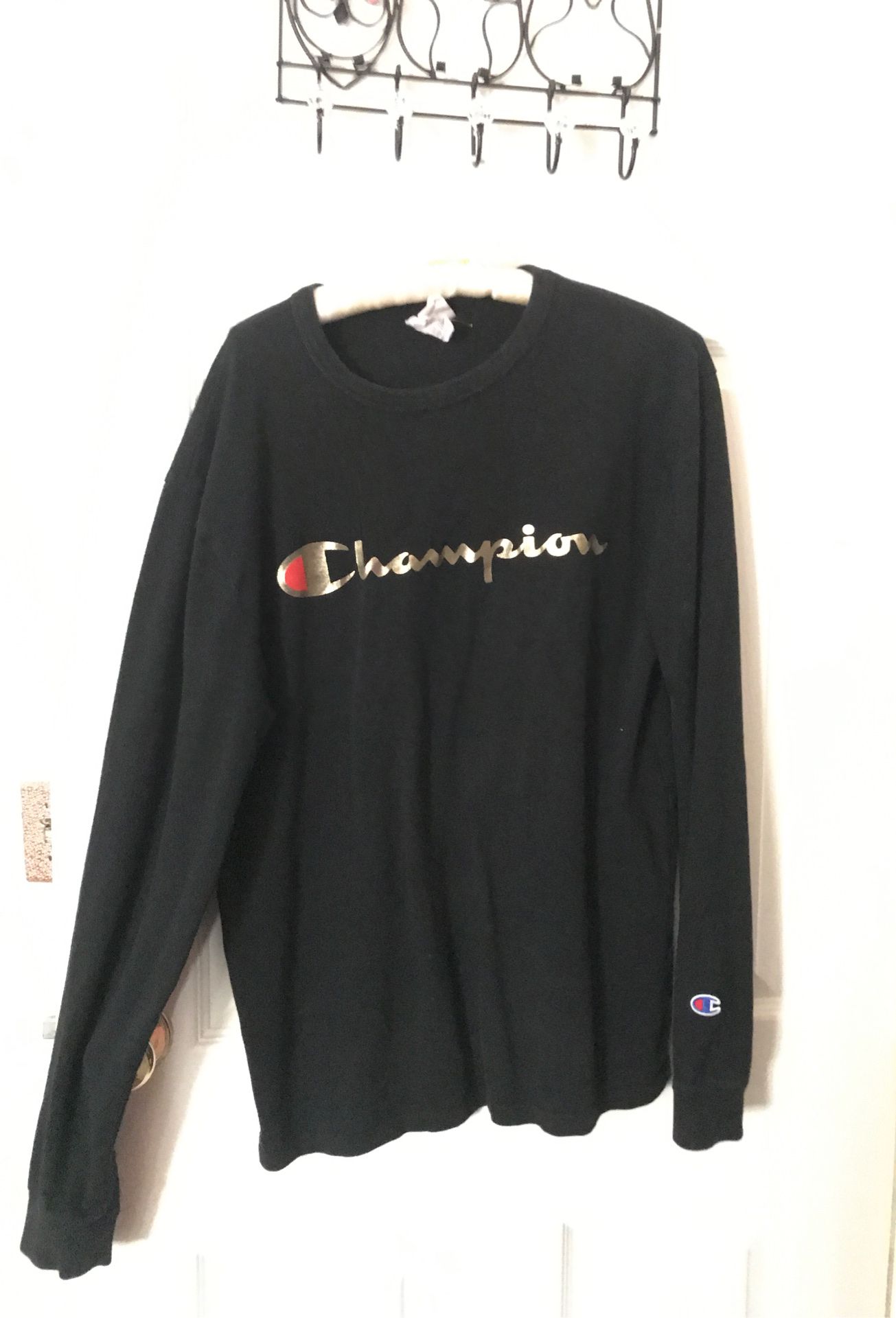 size medium black champion sweater with gold writing